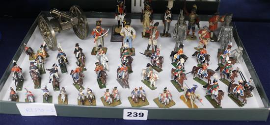 A collection of painted lead figures of soldiers and a model canon